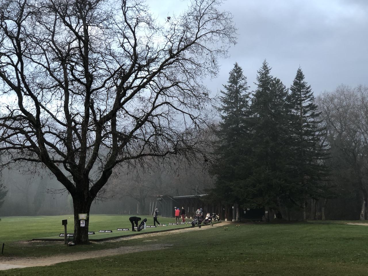 Quelques rares golfeurs au practice, tôt le matin